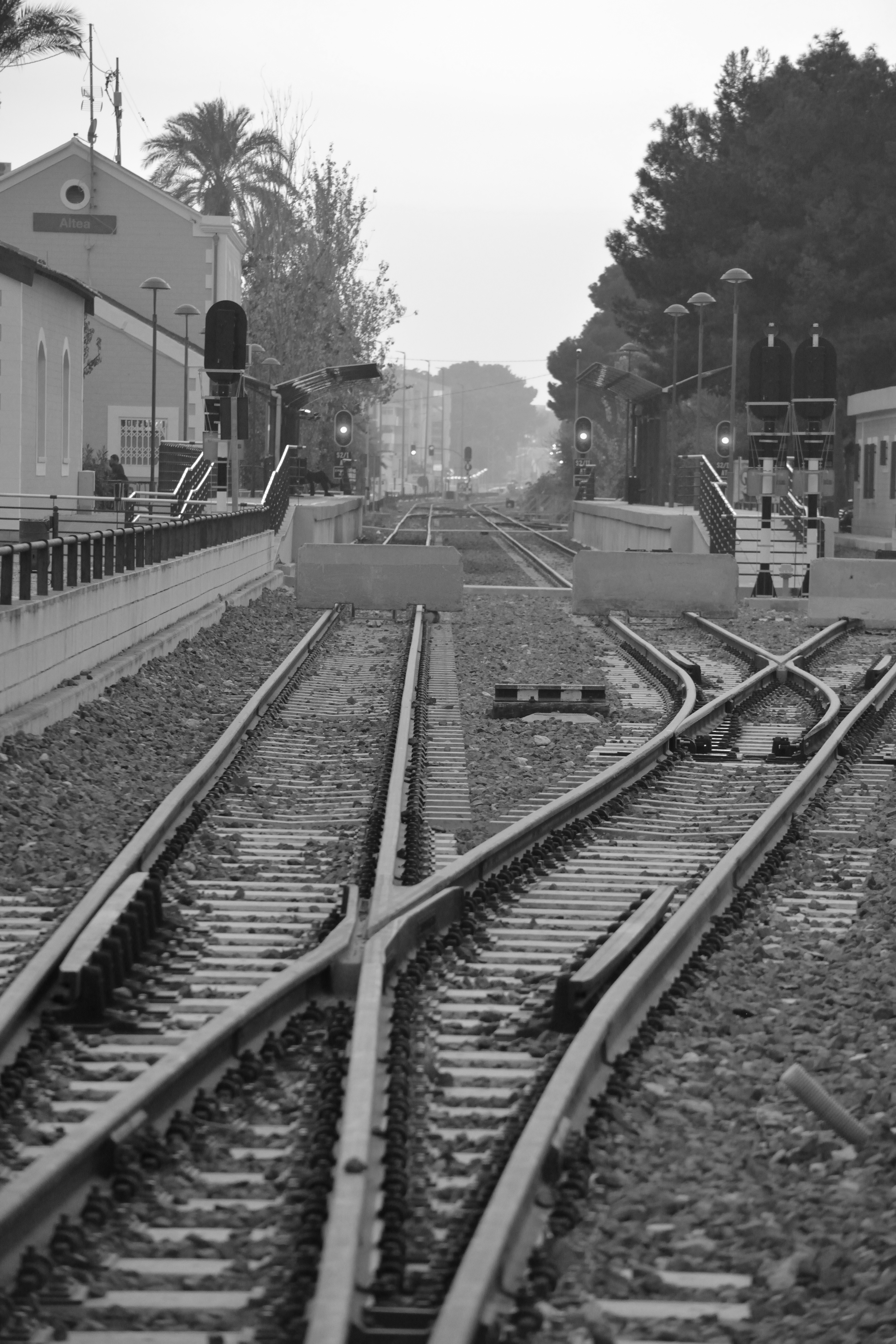 greyscale photo of train railings