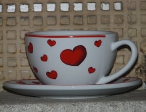 white and  red ceramic heart carved teacup and saucer thumbnail