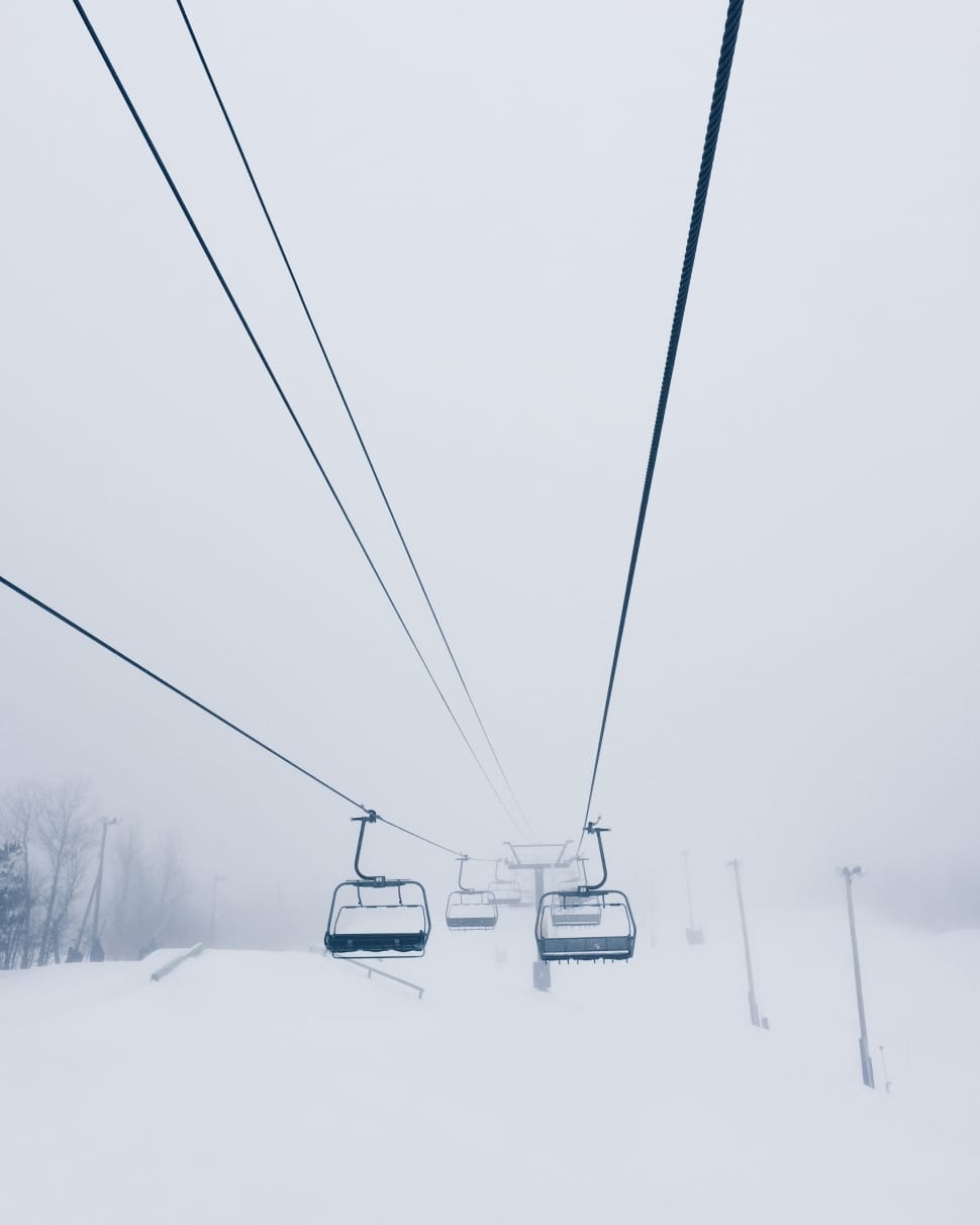 black cable cars in snow coated land preview