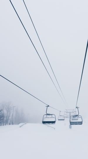 black cable cars in snow coated land thumbnail