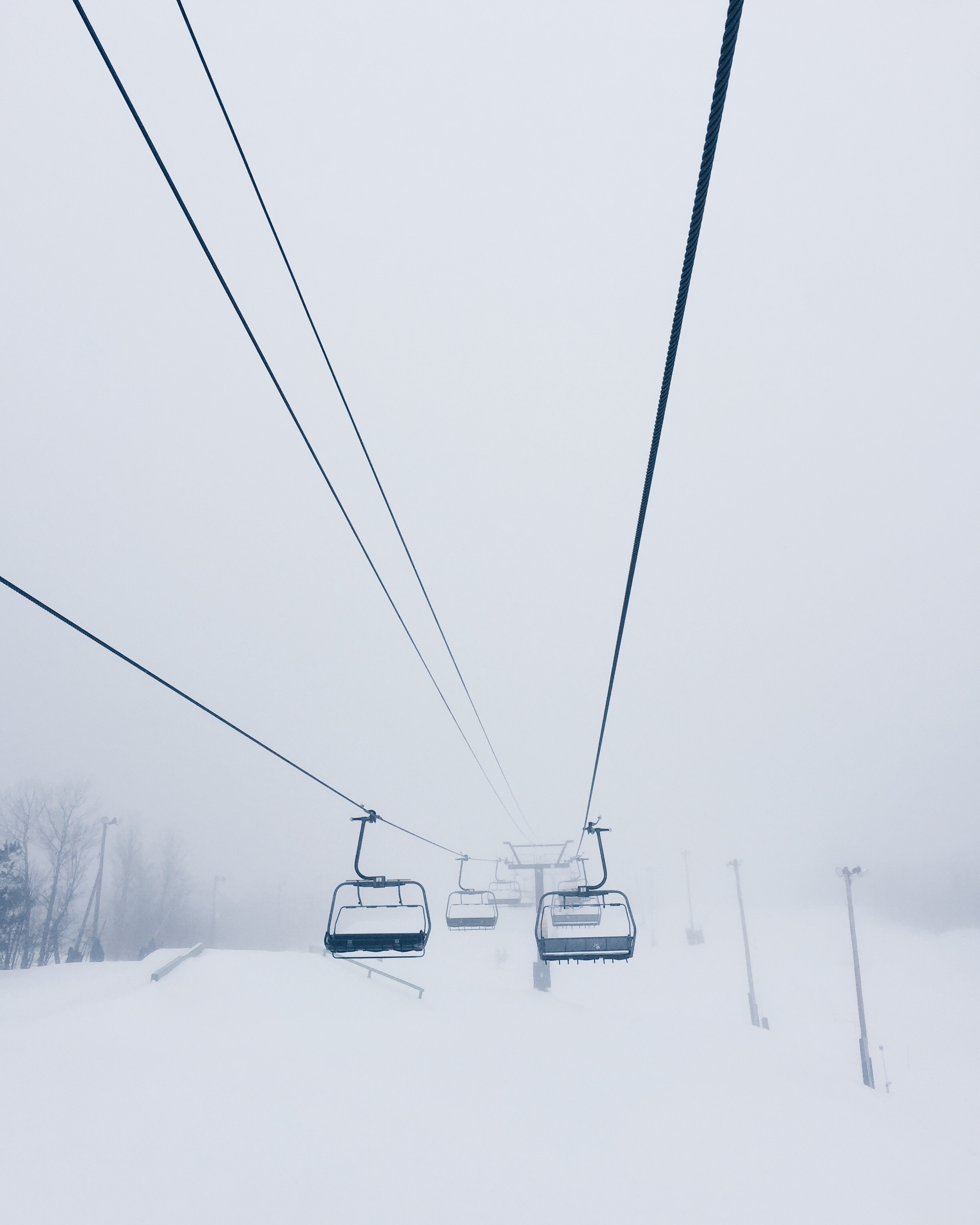 black cable cars in snow coated land