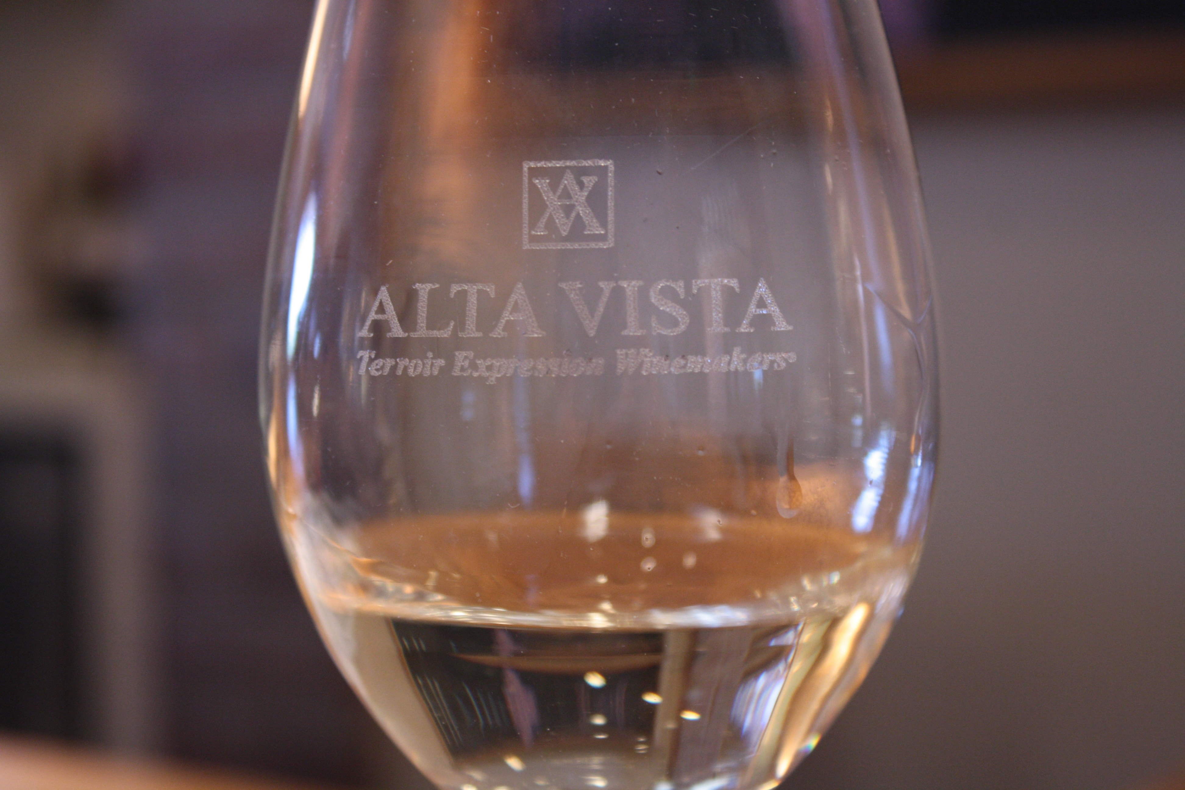 Alta Vista wine glass filled with clear beverage