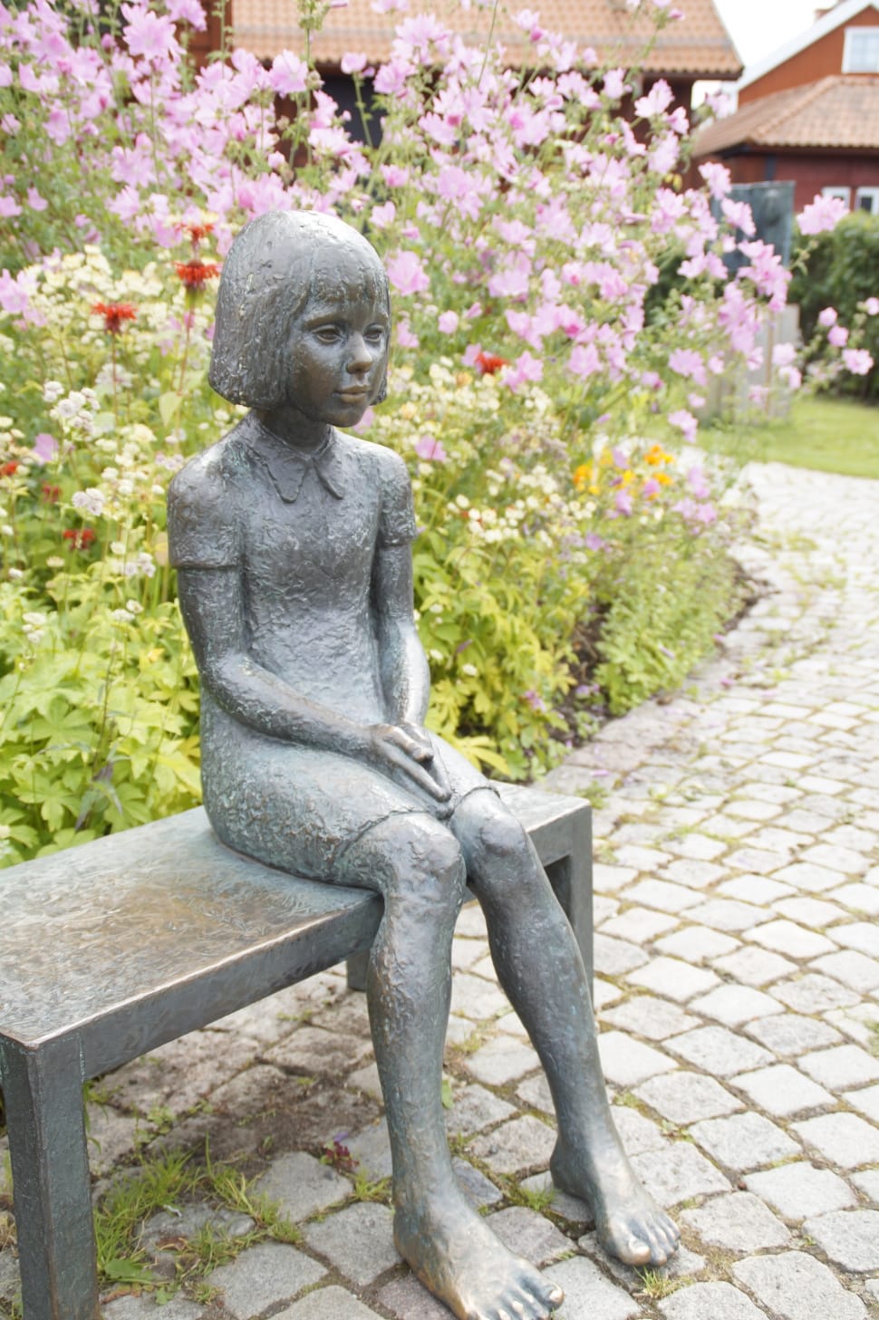 girl gray statue sitting on the bench at the park during daytime preview