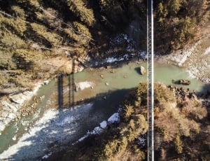 aerial view of stainless steel hanging bridge in the middle of mountain thumbnail