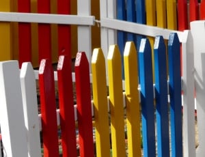 white red yellow and blue wooden fence thumbnail