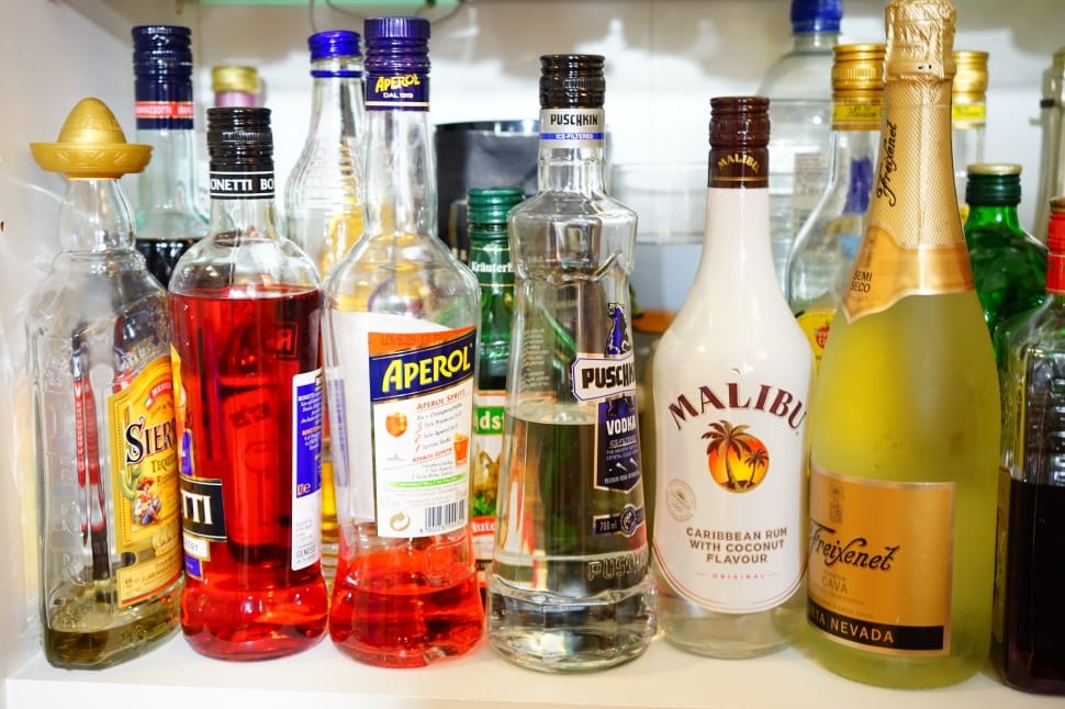 liquor bottle collection on white shelf preview