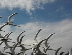 flock of white birds statue thumbnail