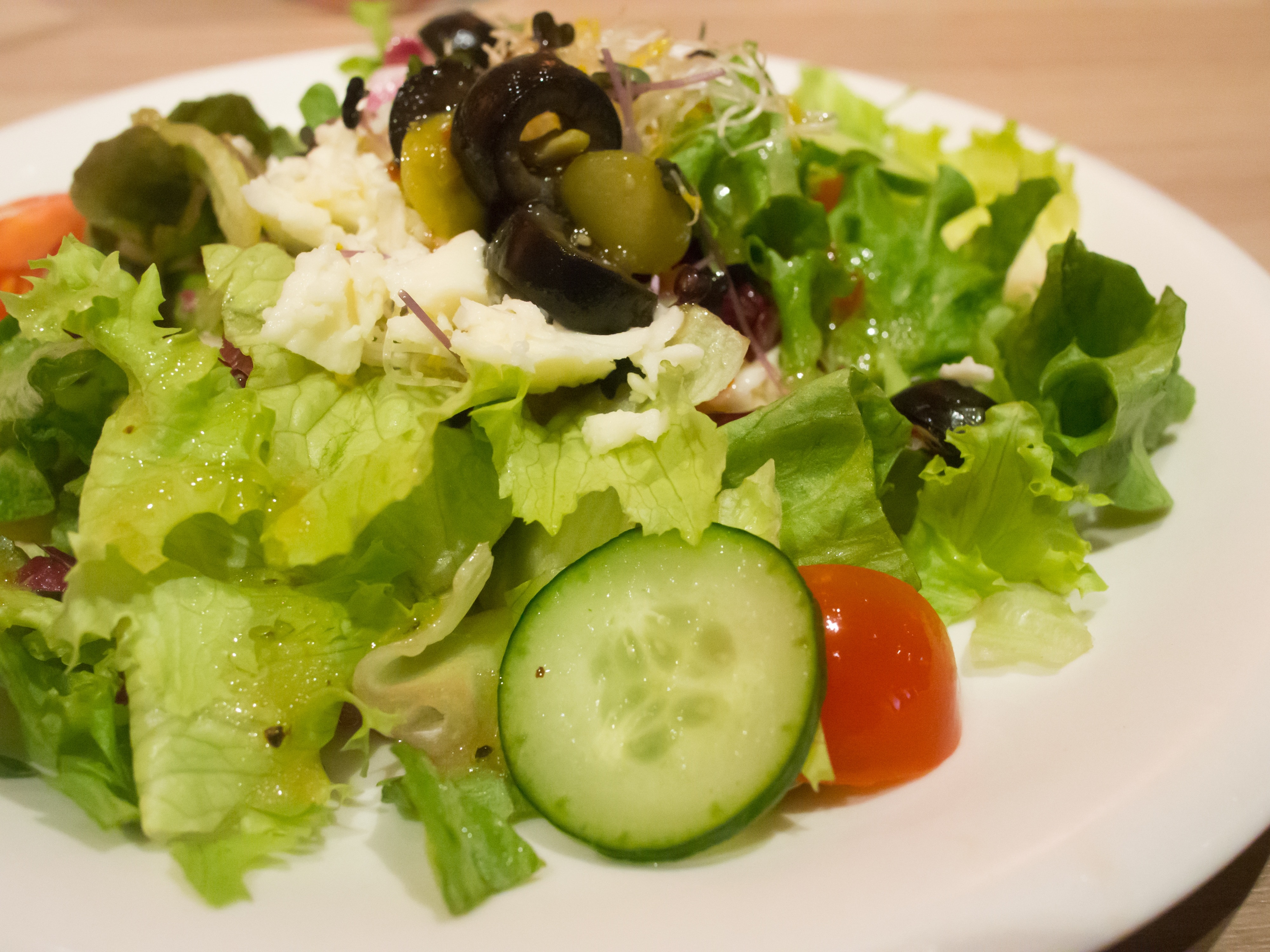 greens in white salad plate