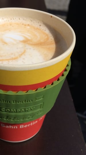 yellow and red disposable cup filled of coffee late thumbnail