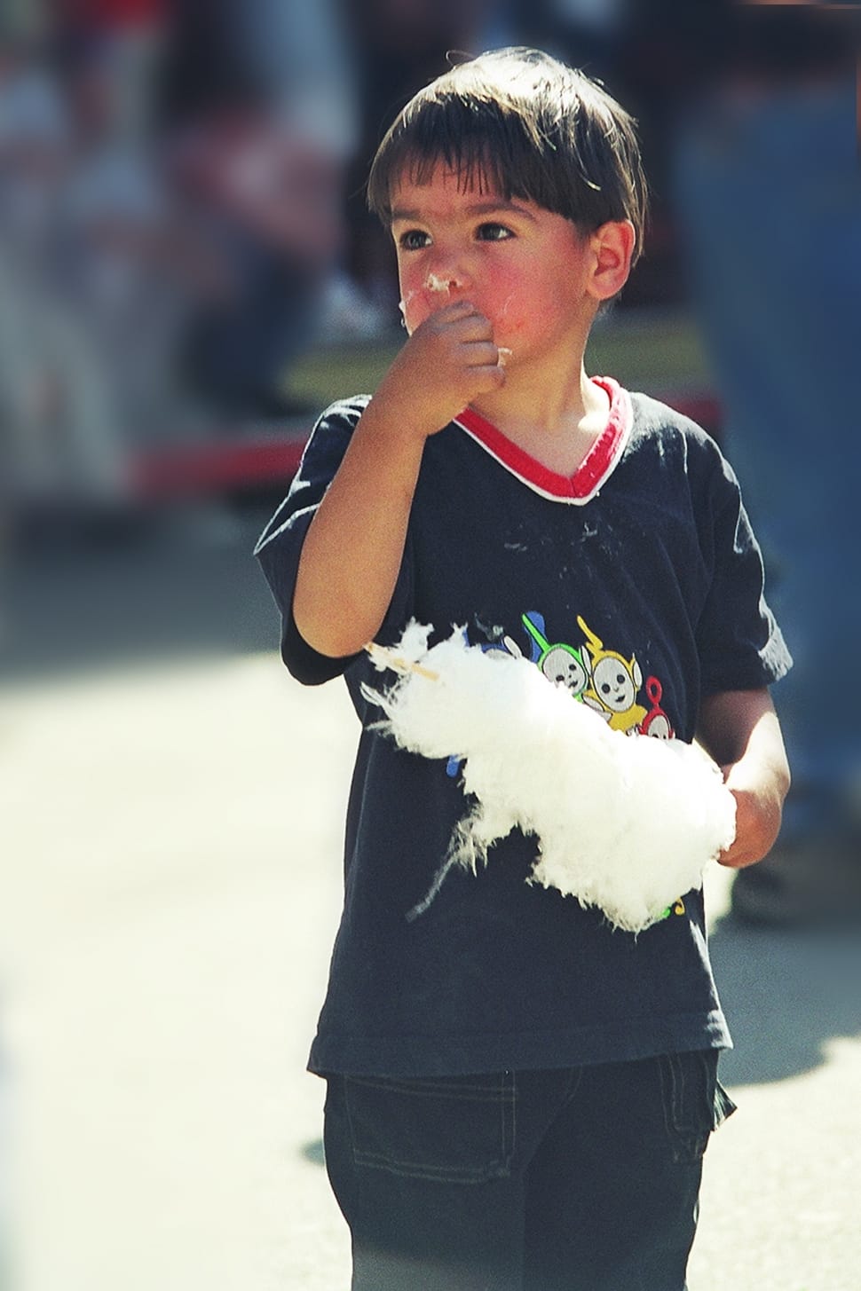 boy eating white cotton candy preview