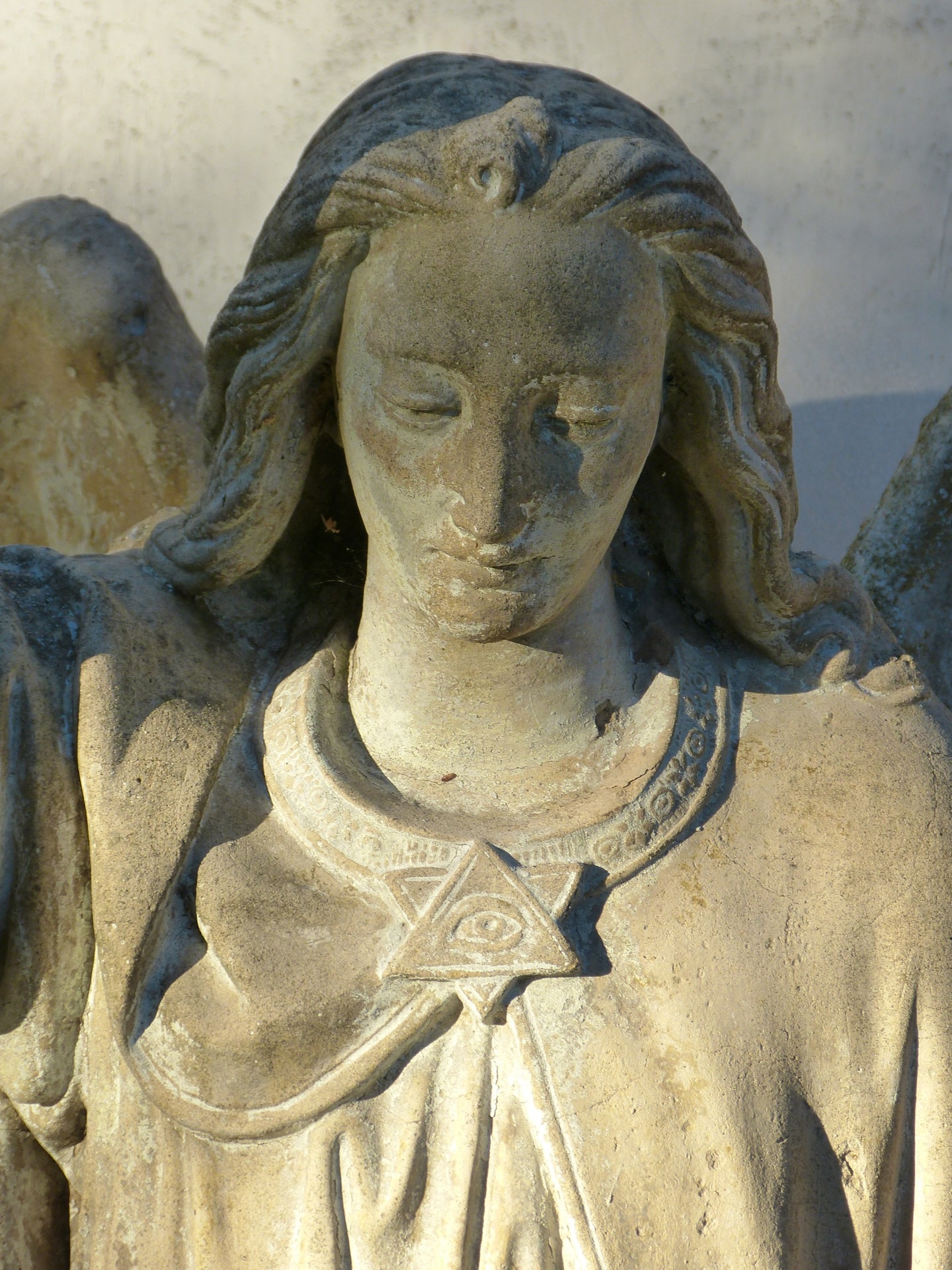 woman angel with eye pin on dress figurine