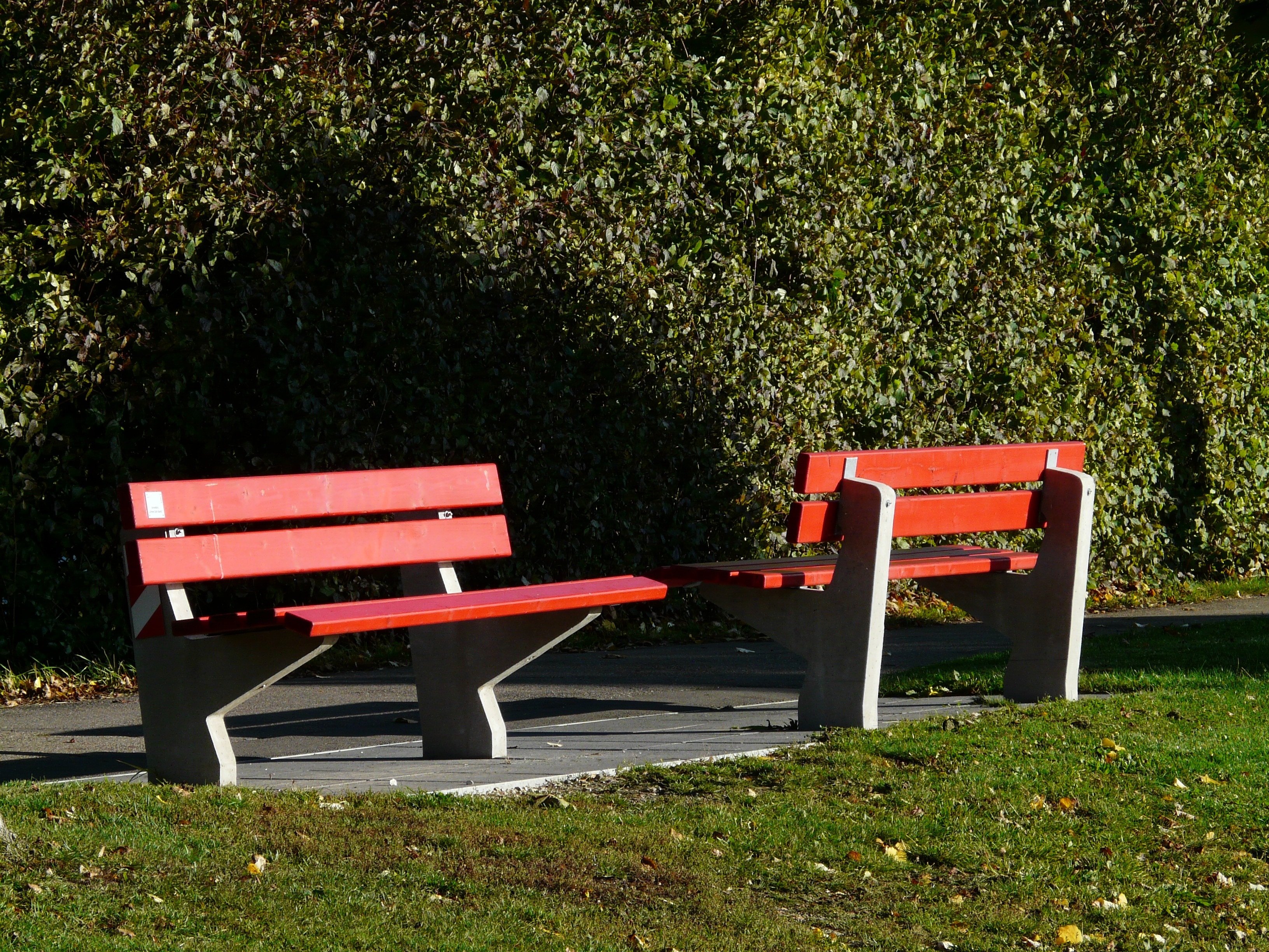 2 gray and red wooden bench