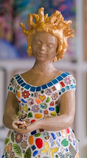 woman in multicolored dress figurine thumbnail