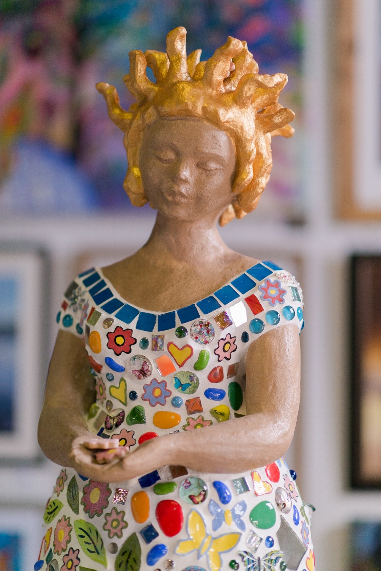 woman in multicolored dress figurine