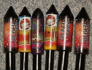 six black fireworks on gray surface thumbnail