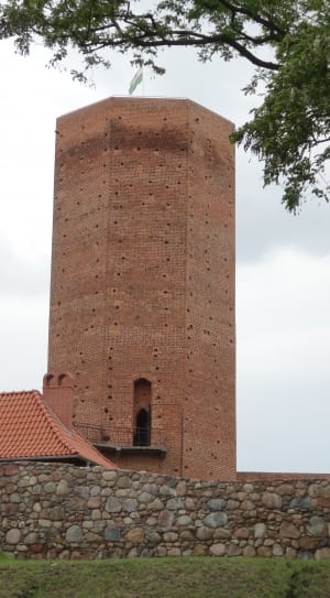 photo of brown concrete tower with stone walls thumbnail