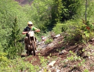 human riding on the motocross dirt bike on the mountain during daytime thumbnail