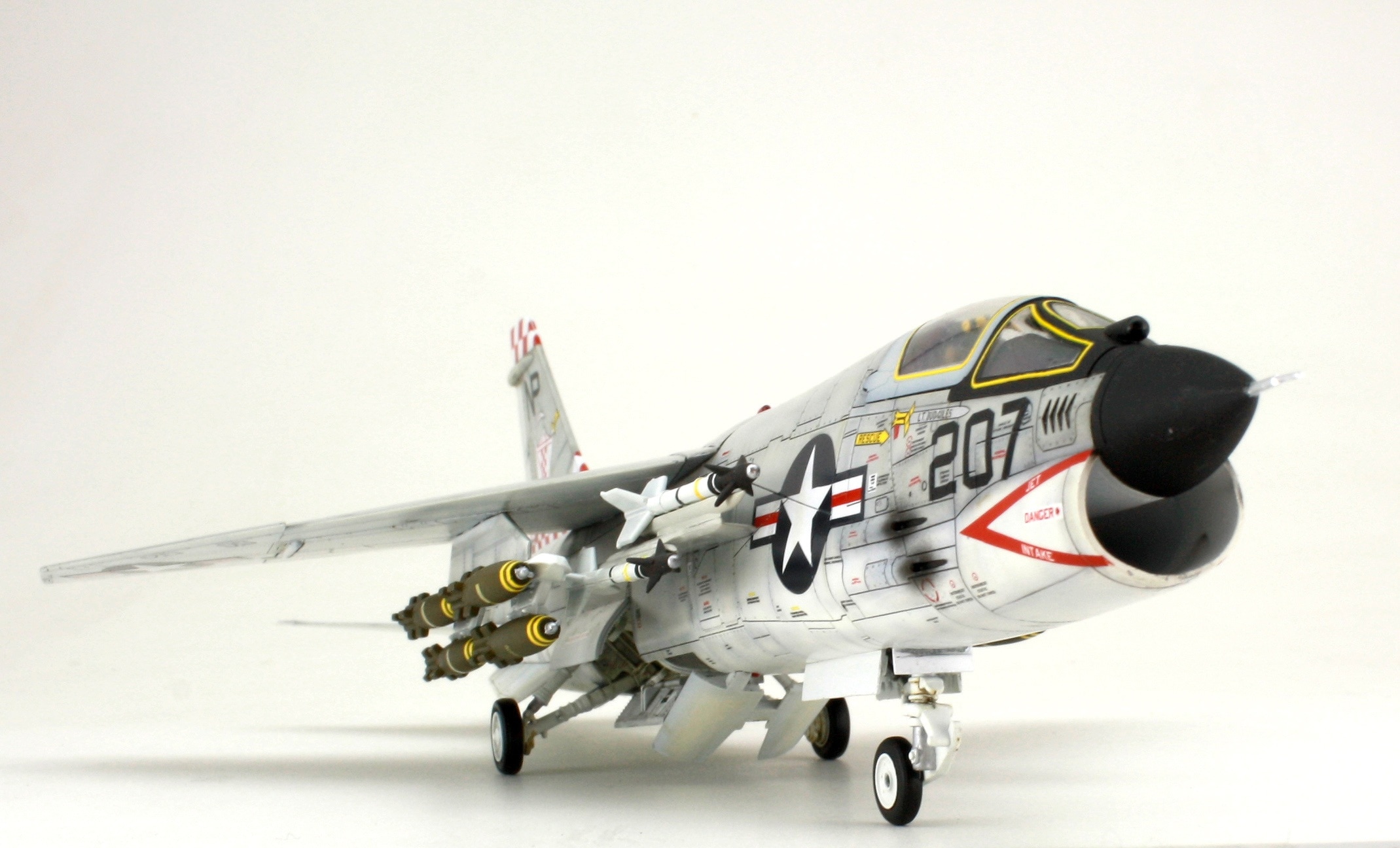 white gray red and black fighter plane scale model