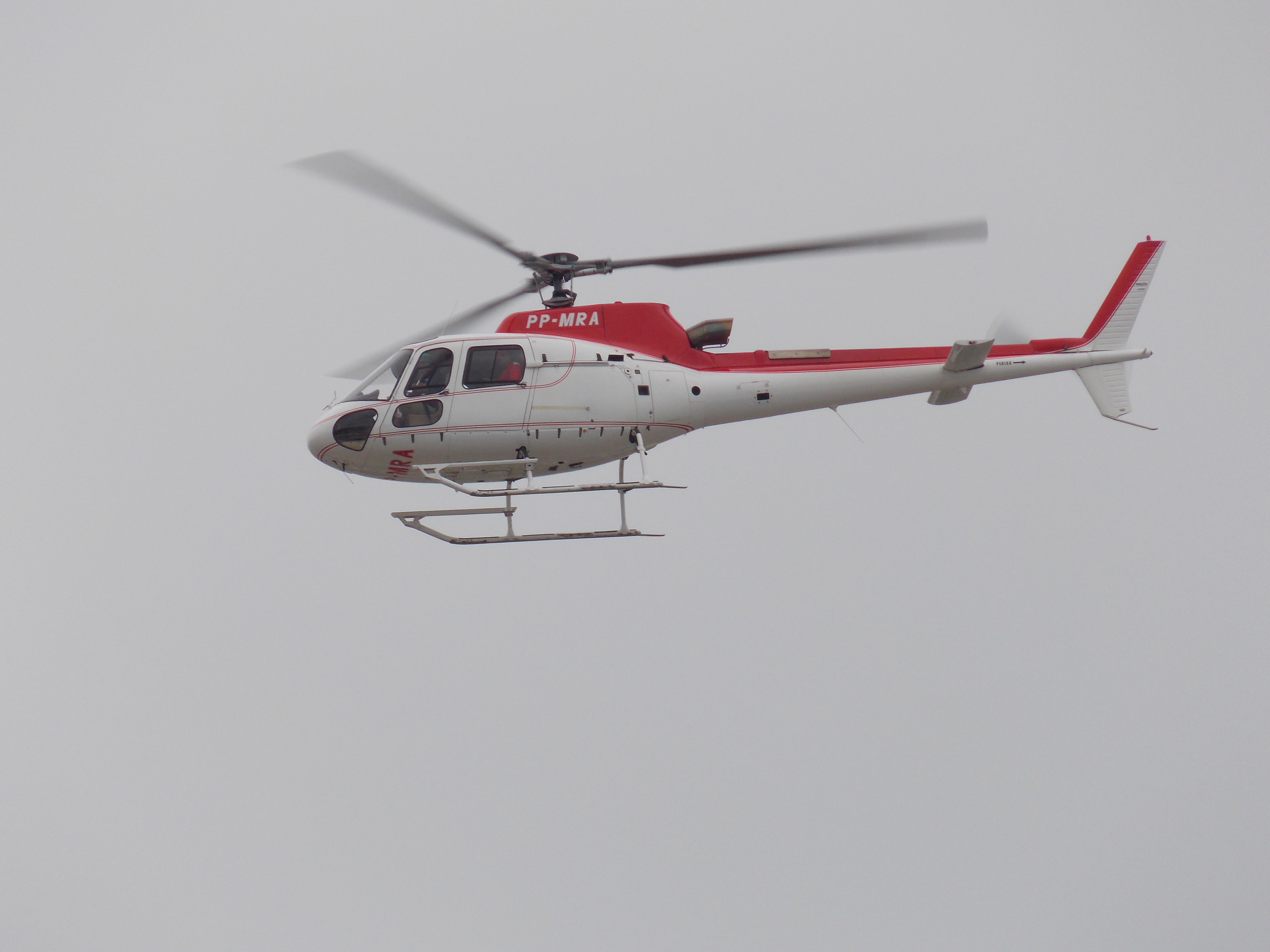 white and red pp-mra helicopter