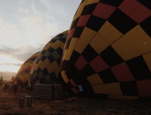 3 yellow black and red hot air balloons thumbnail