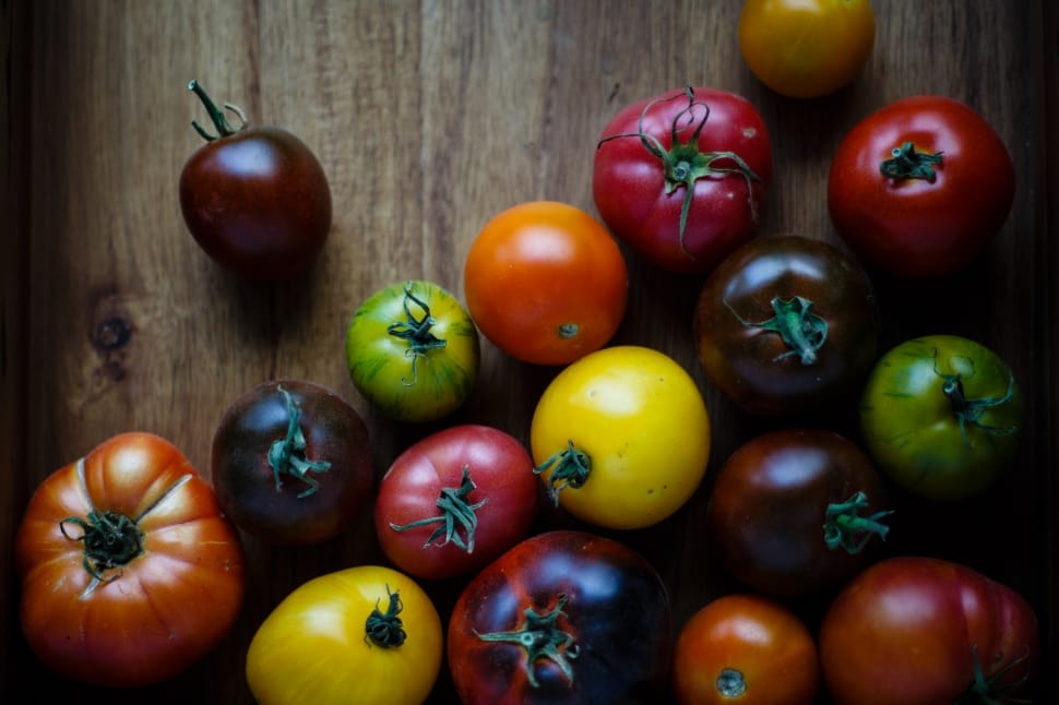 still life photography of tomatoes on wooden surface preview