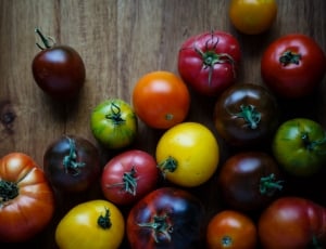 still life photography of tomatoes on wooden surface thumbnail