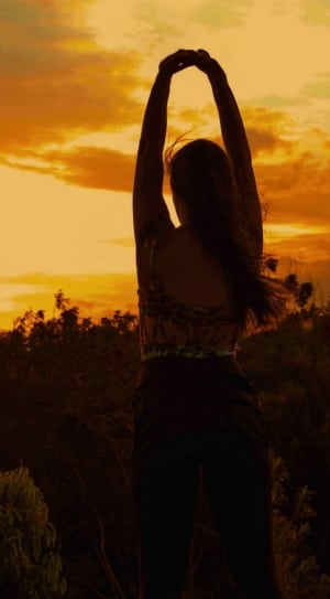 woman stretching during golden hour thumbnail
