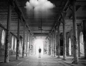 grayscale photography of man inside the temple thumbnail