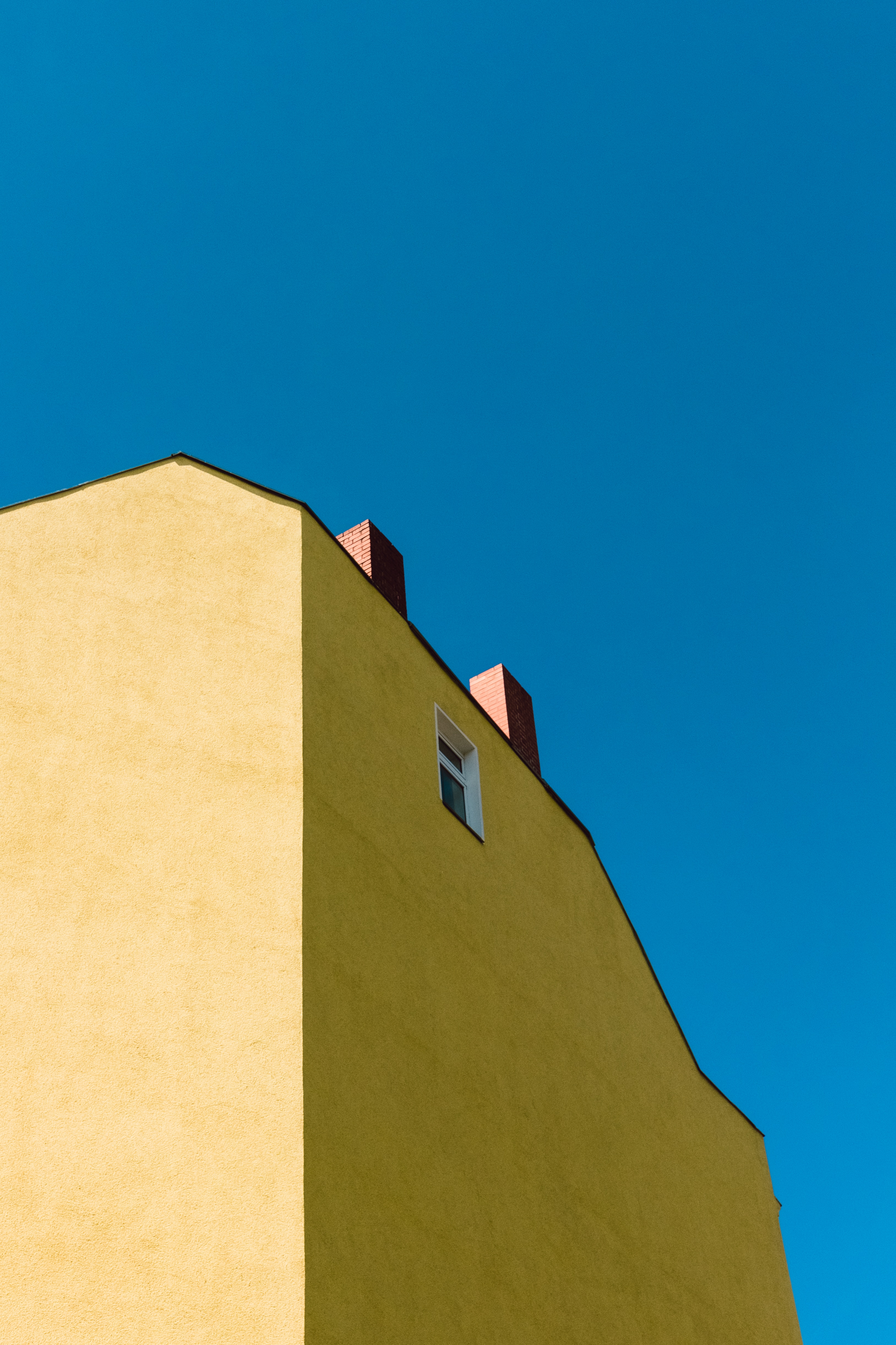 yellow and brown concrete building under blue sky