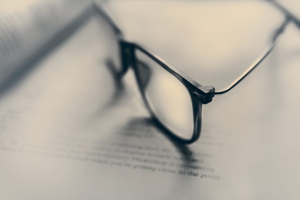 black frame eyeglasses on book preview
