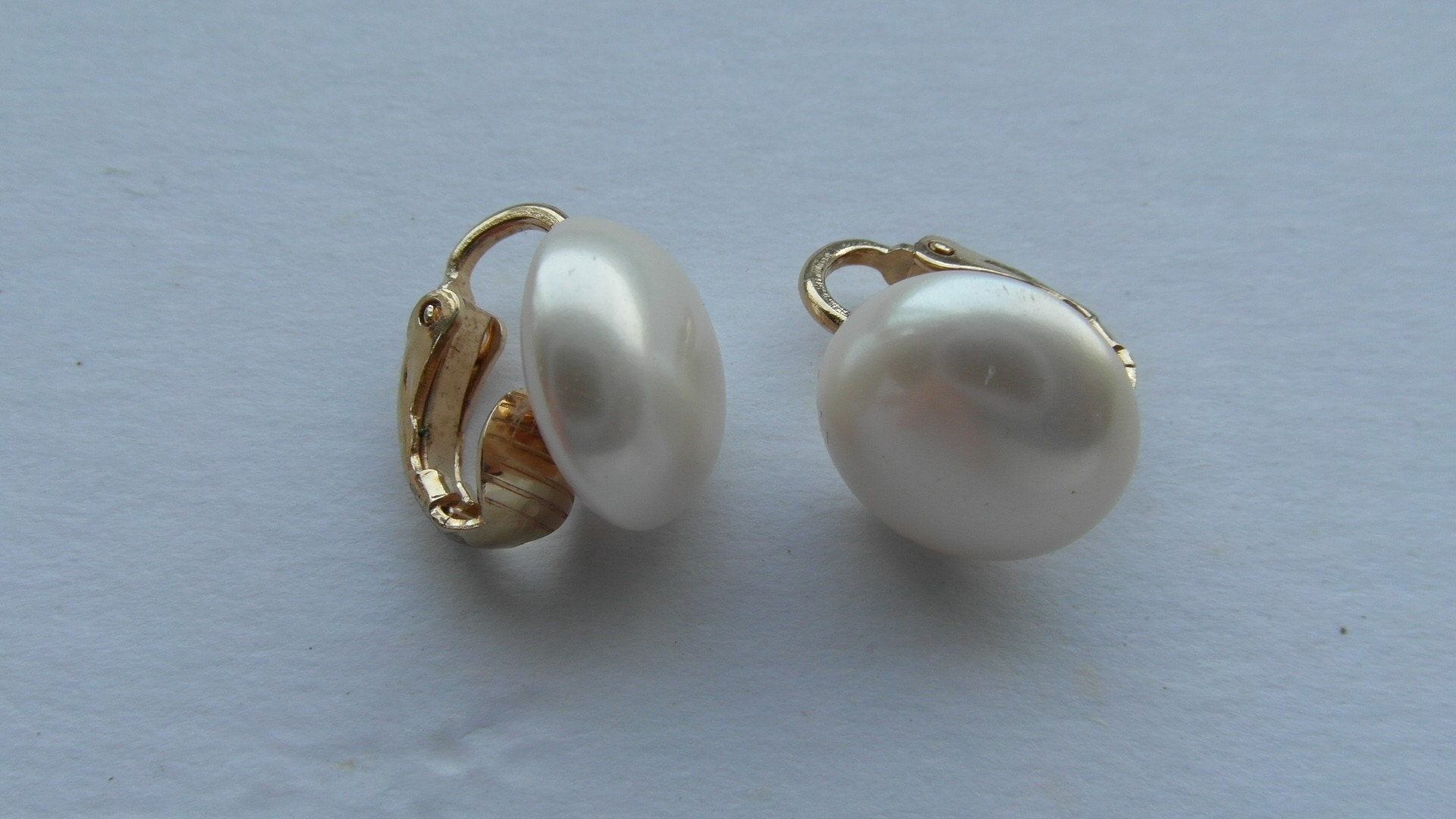pair of white and gold pearl earrings