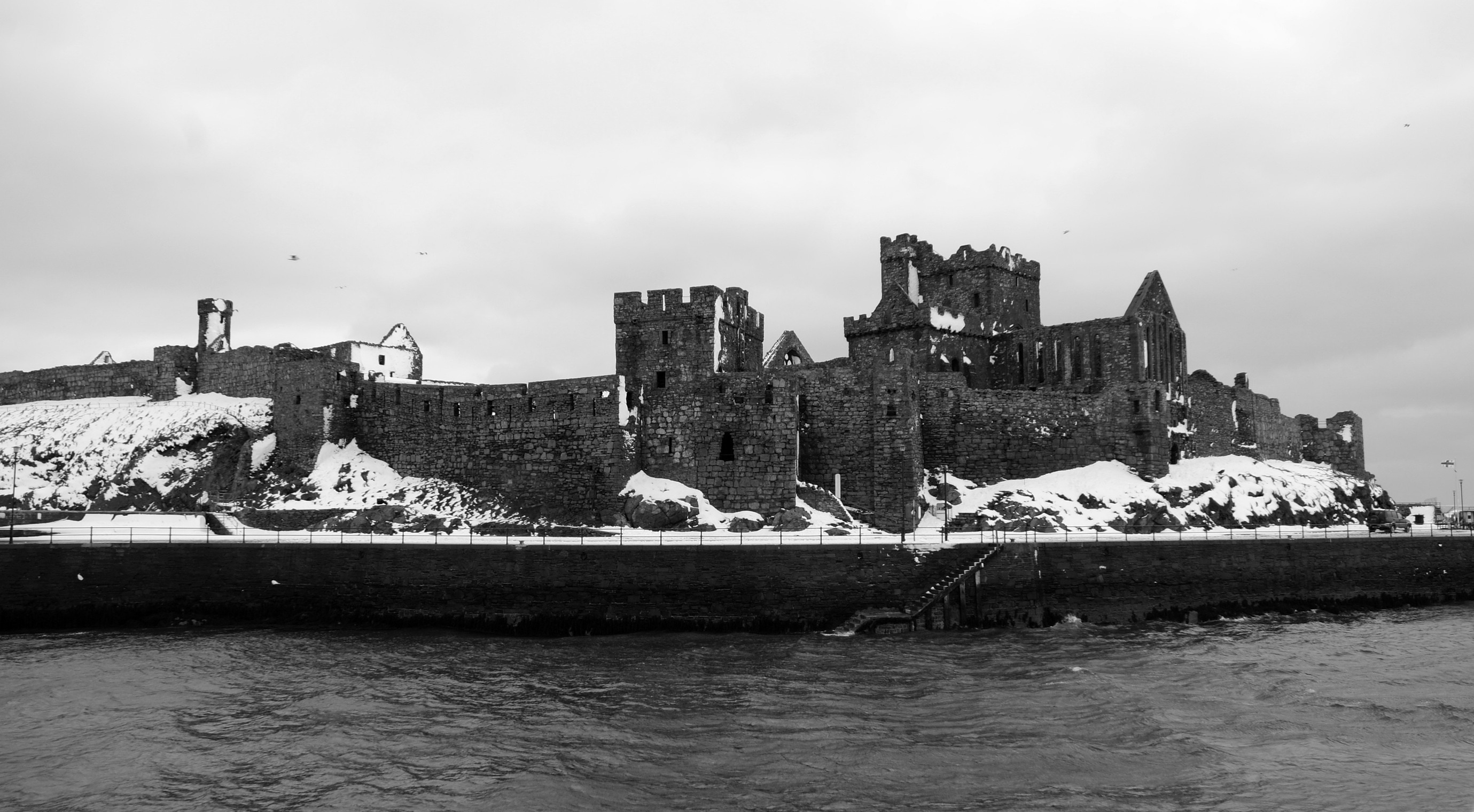 castle beside body of water photo