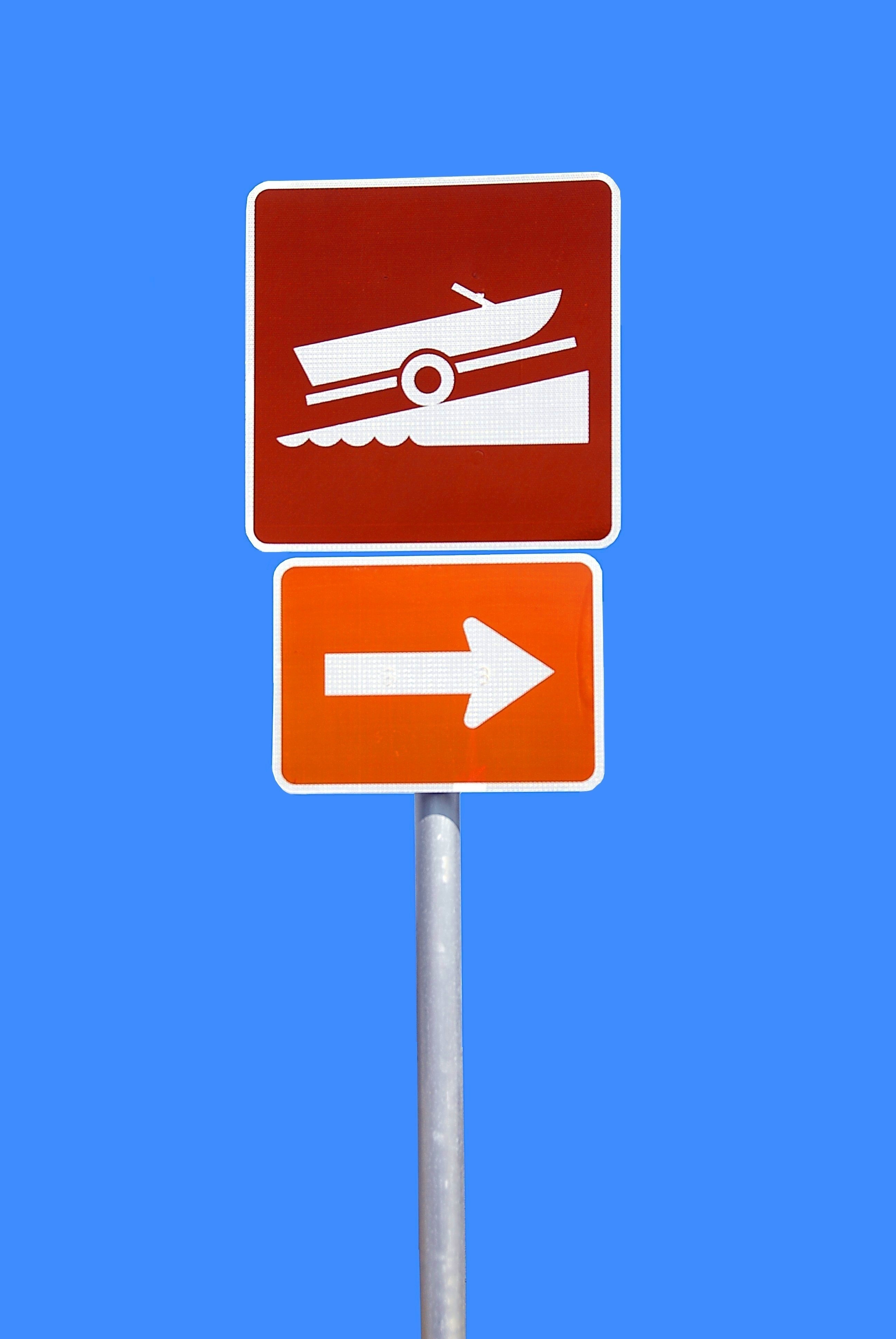 red orange and gray vehicle and arrow road sign