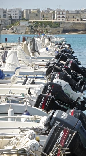 black outboard motors on boat near body of waters during daytime thumbnail