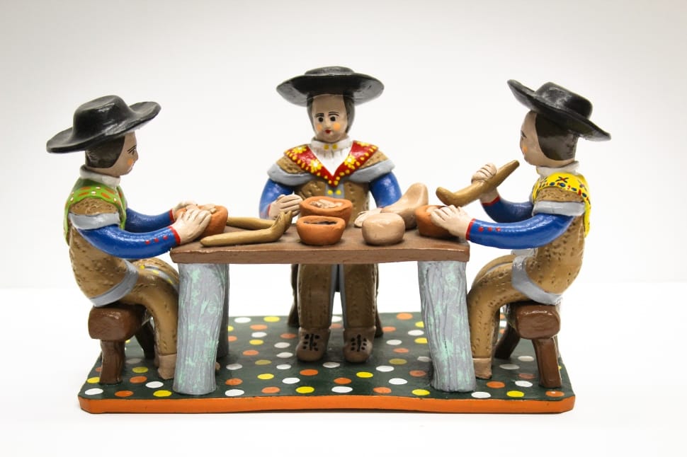 mariachi sitting on chair near table figurine preview
