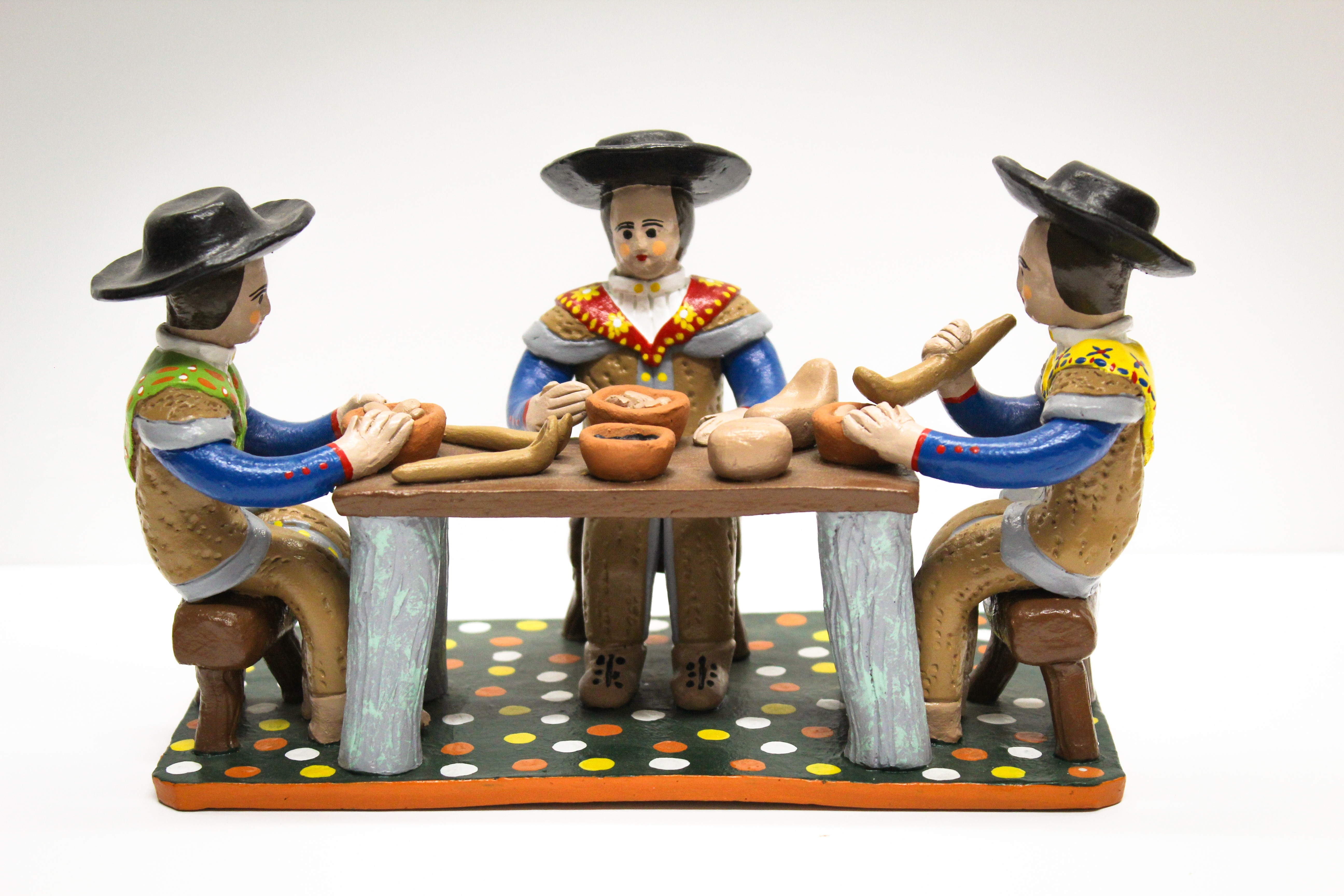 mariachi sitting on chair near table figurine