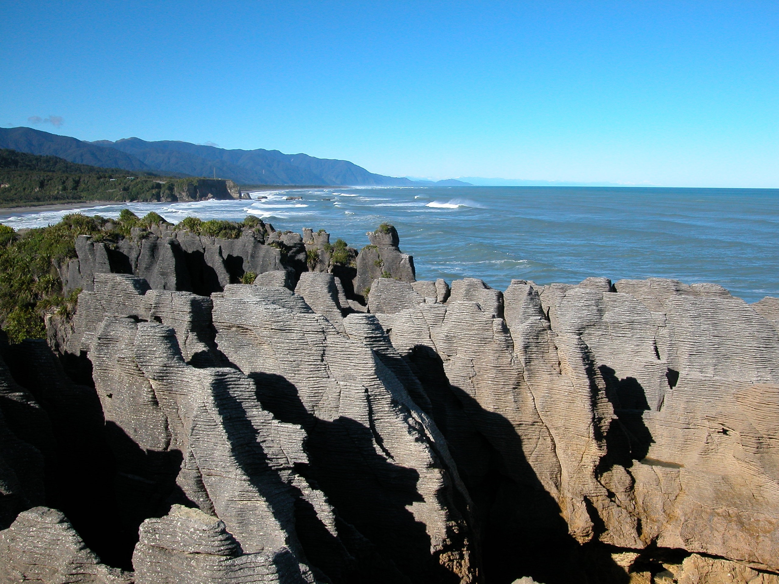 brown rock formations near sea