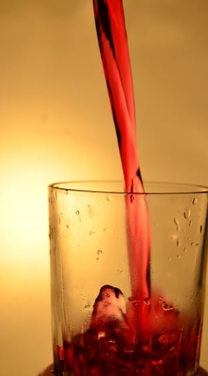 drinking glass filled with red liquor thumbnail