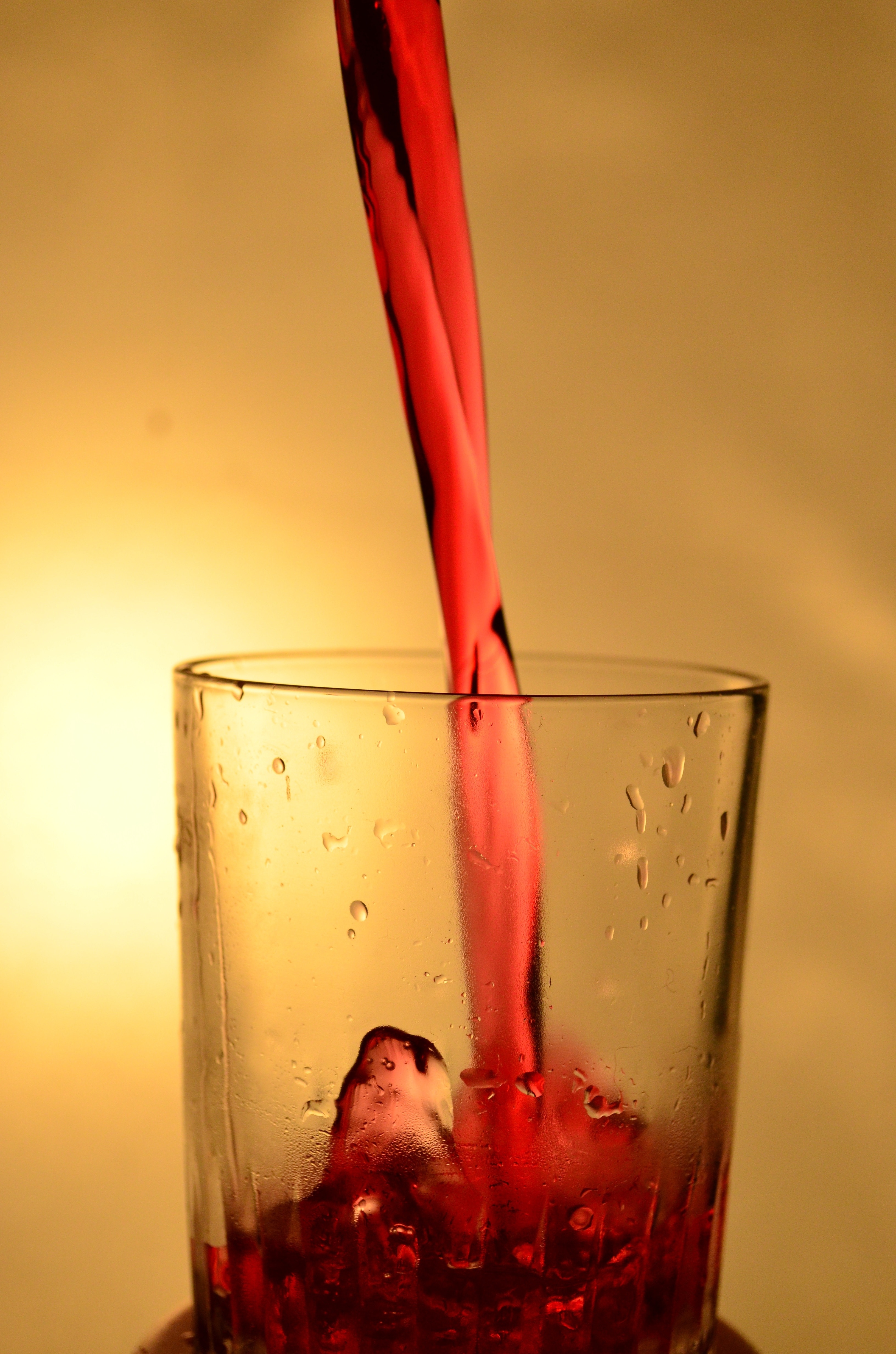 drinking glass filled with red liquor