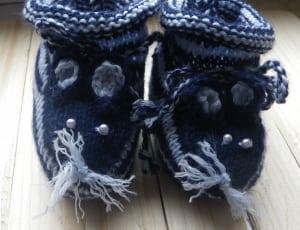baby's white and black knitted shoes thumbnail