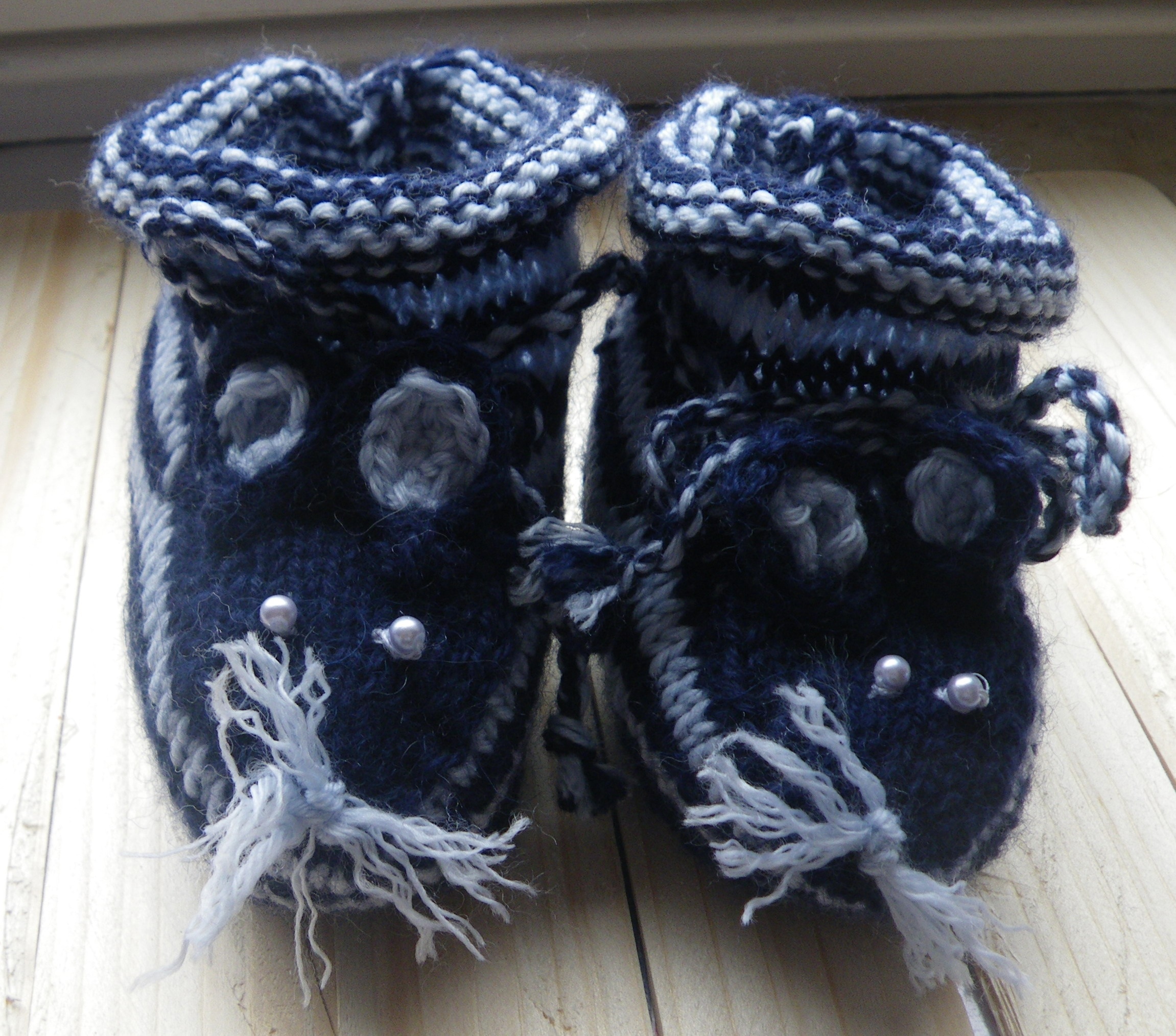 baby's white and black knitted shoes