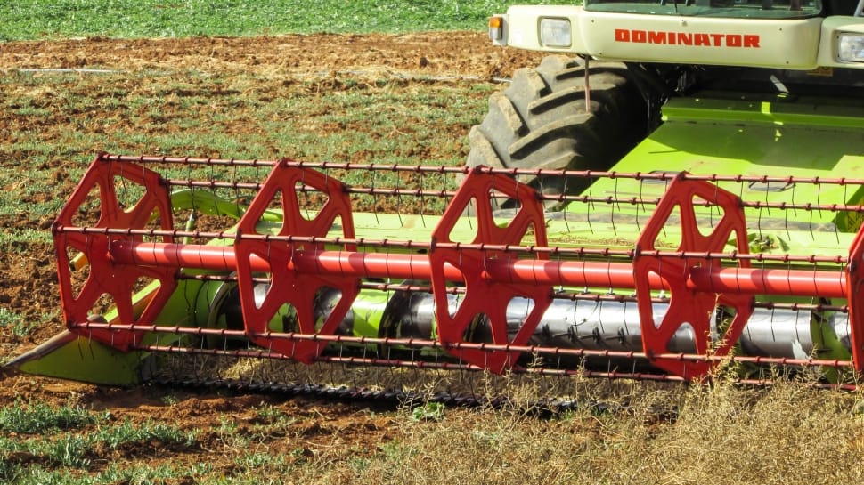red and green Dominator cultivator on green field preview