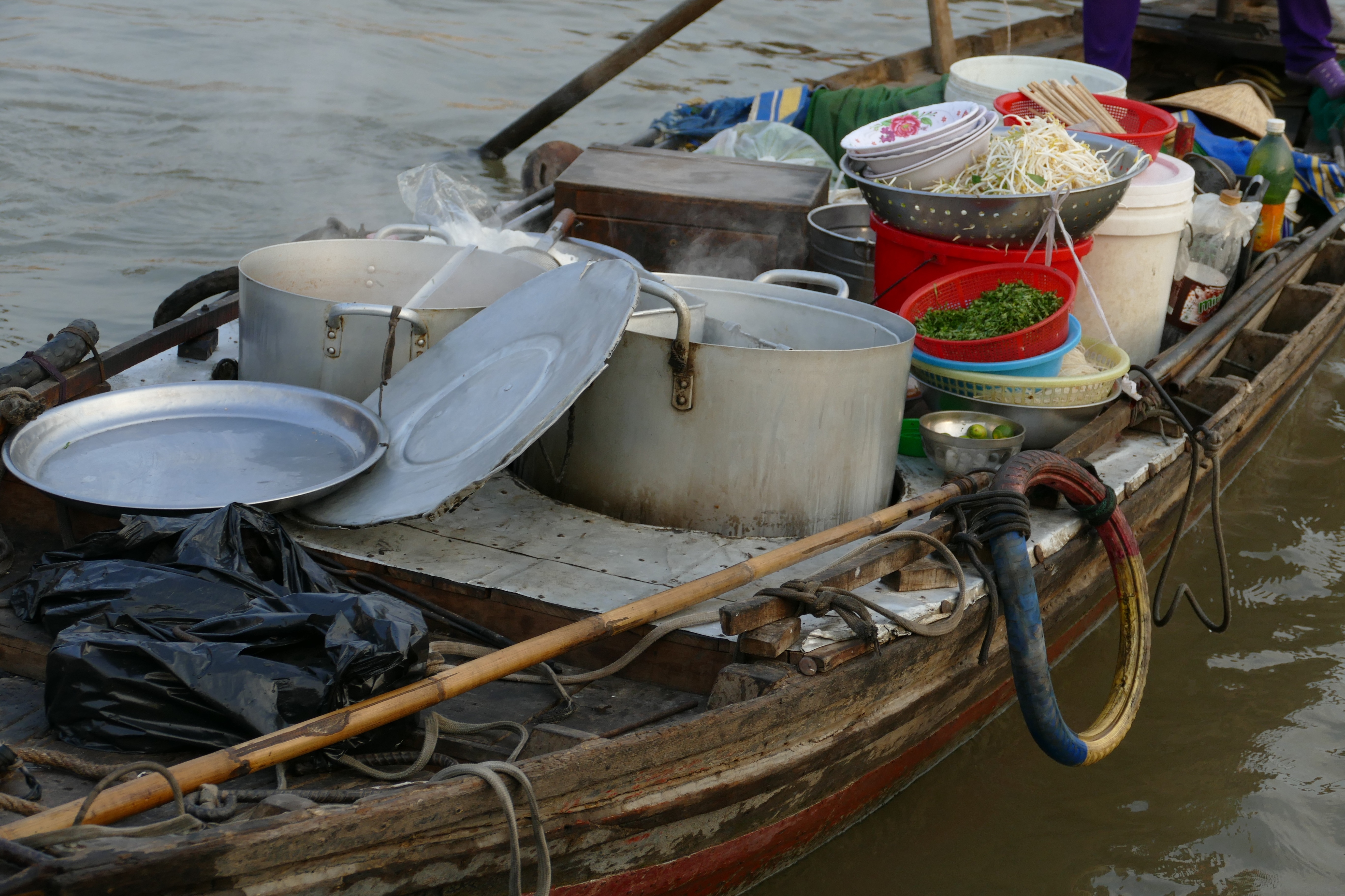 assorted pot on wooden boat