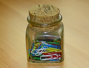 paper clip lot on glass container thumbnail
