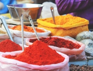red, yellow and orange powders in white plastics thumbnail