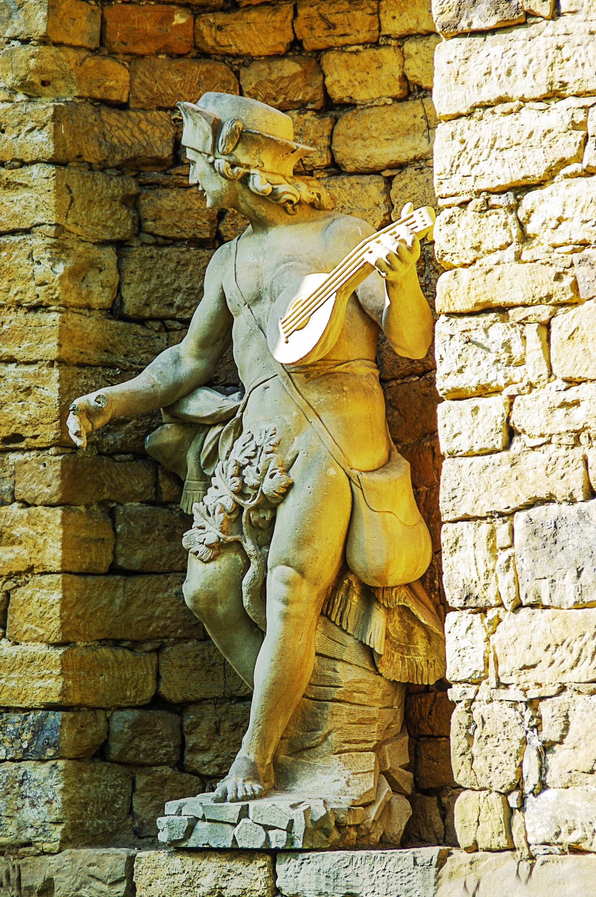 man holding ukulele gray concrete statue