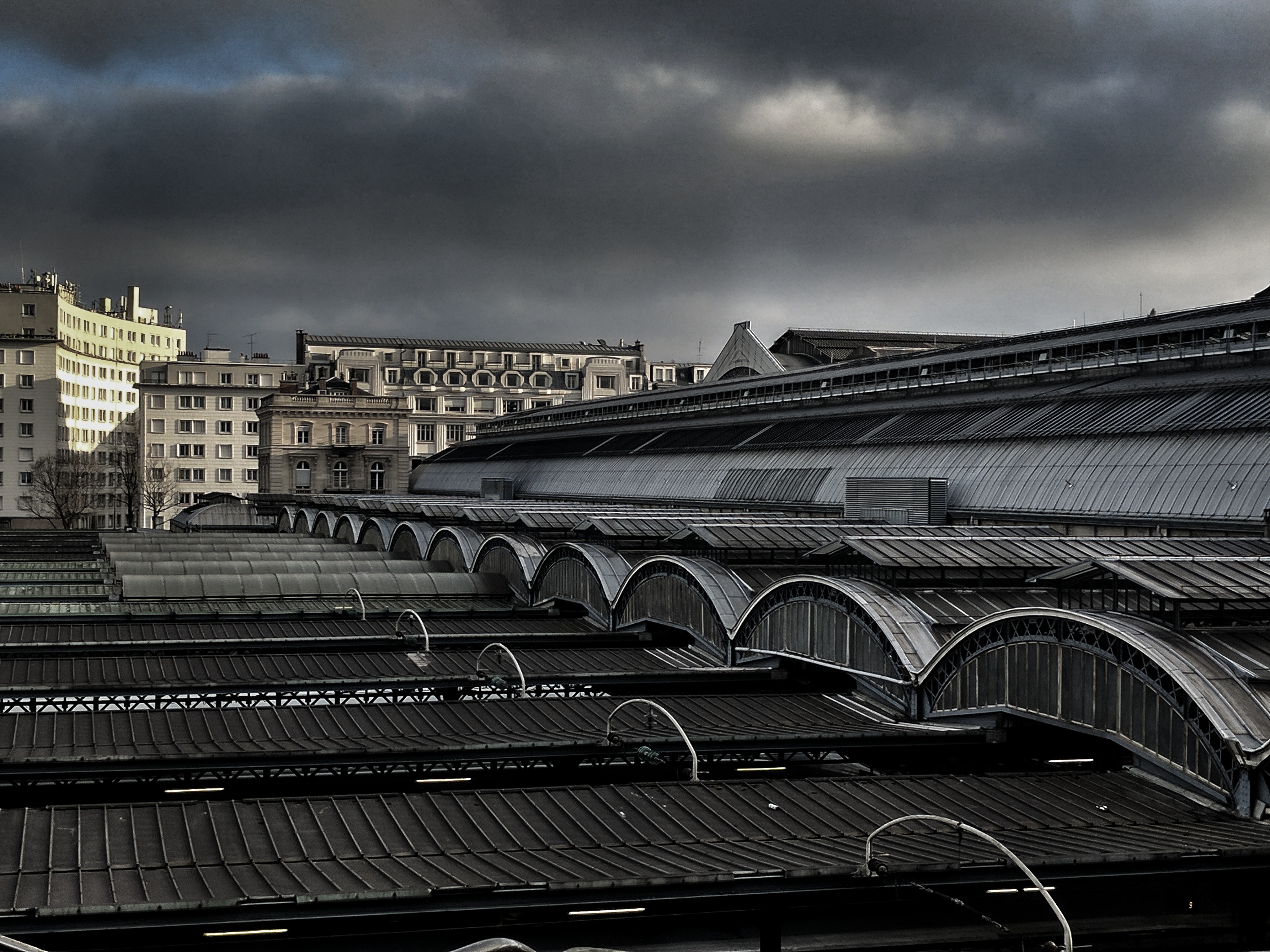 gray building roof under cloudy sky at daytime