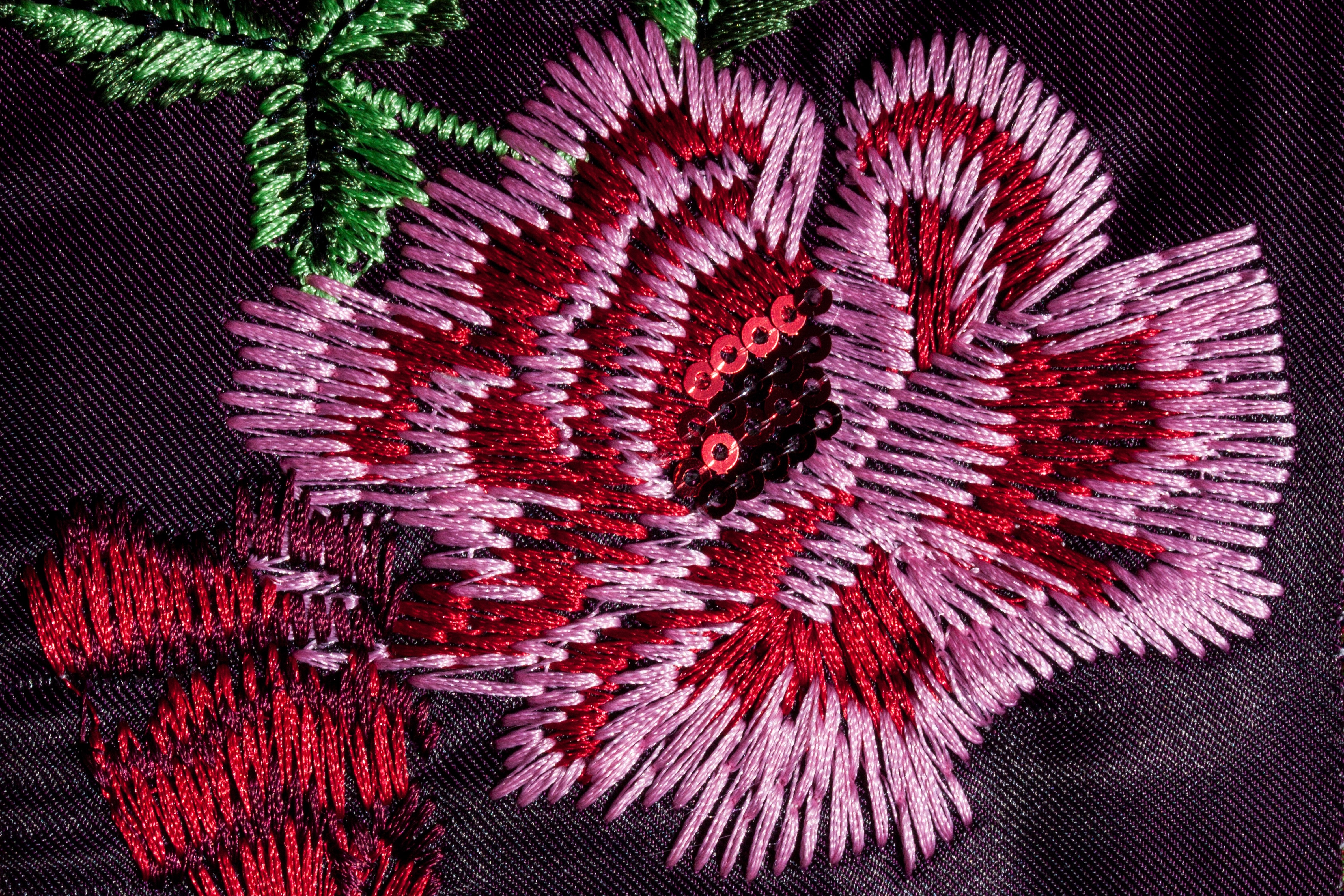 pink red black and green floral textile