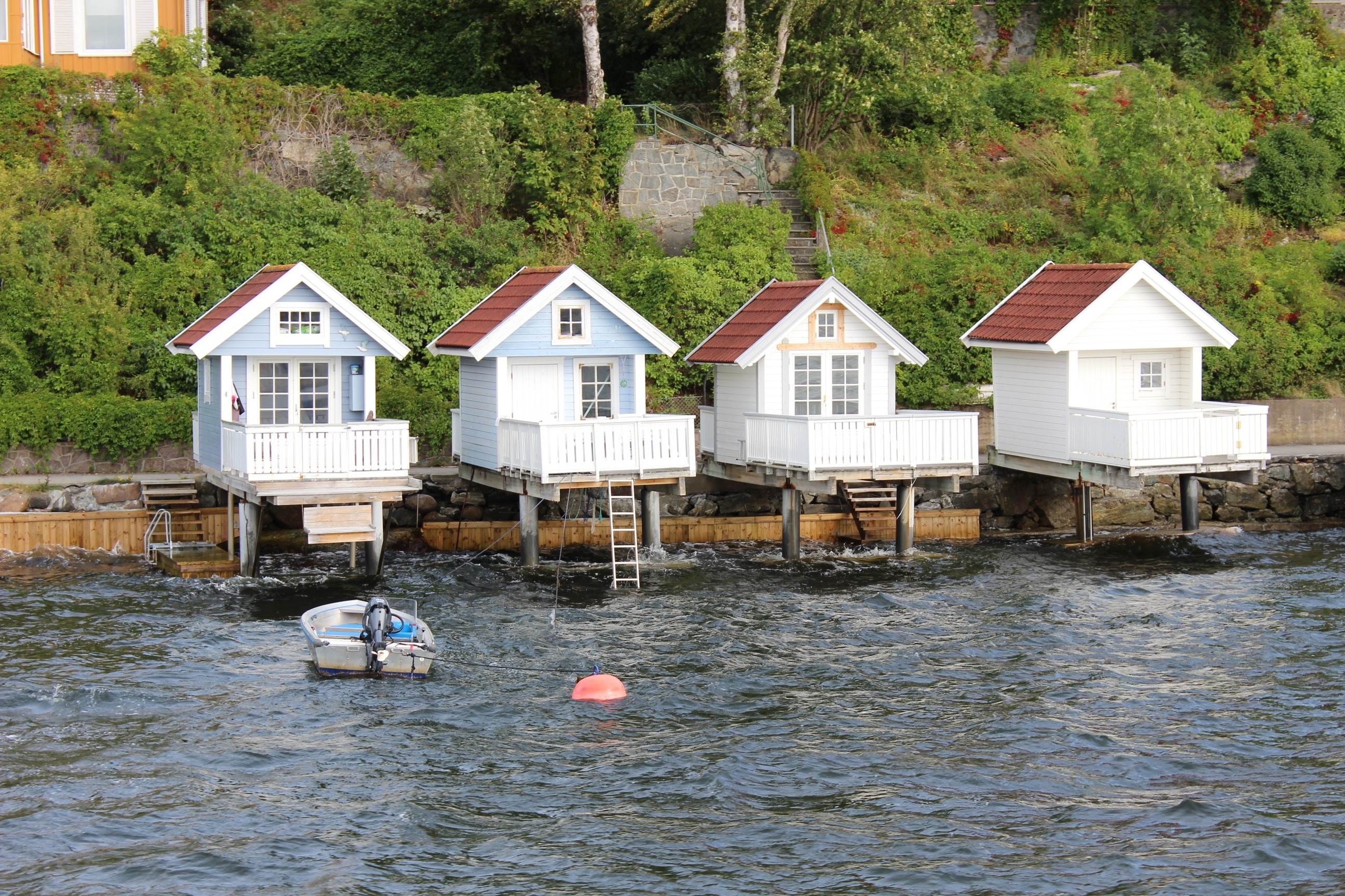 4 white wooden cabins