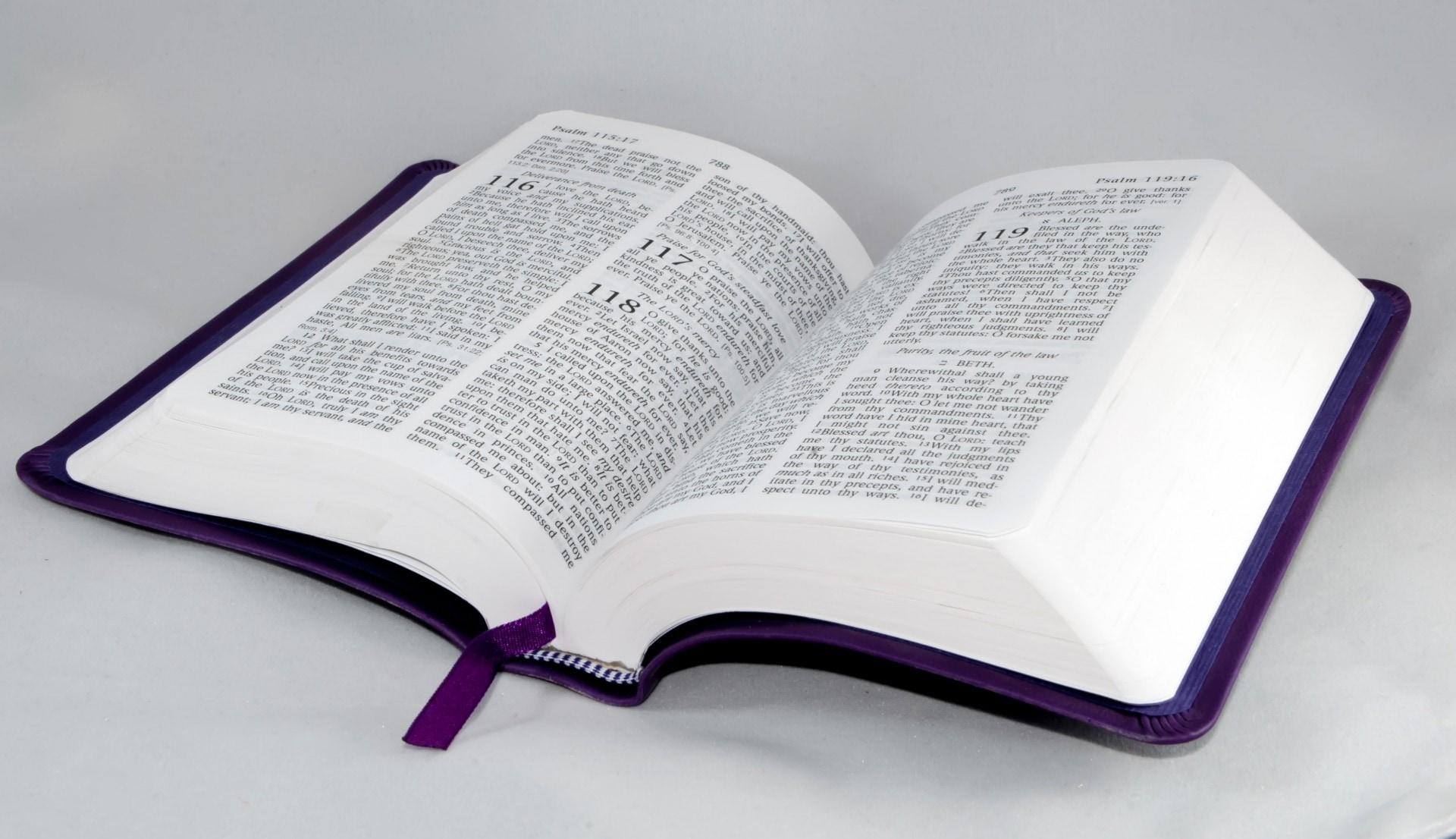 opened Bible with black leather case and purple ribbon bookmark